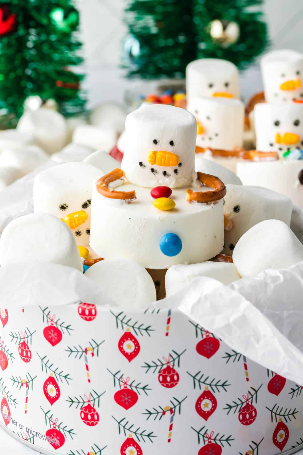 a Completed Cookie sitting in a Cookie Tin with Many Cookies displayed behind it.