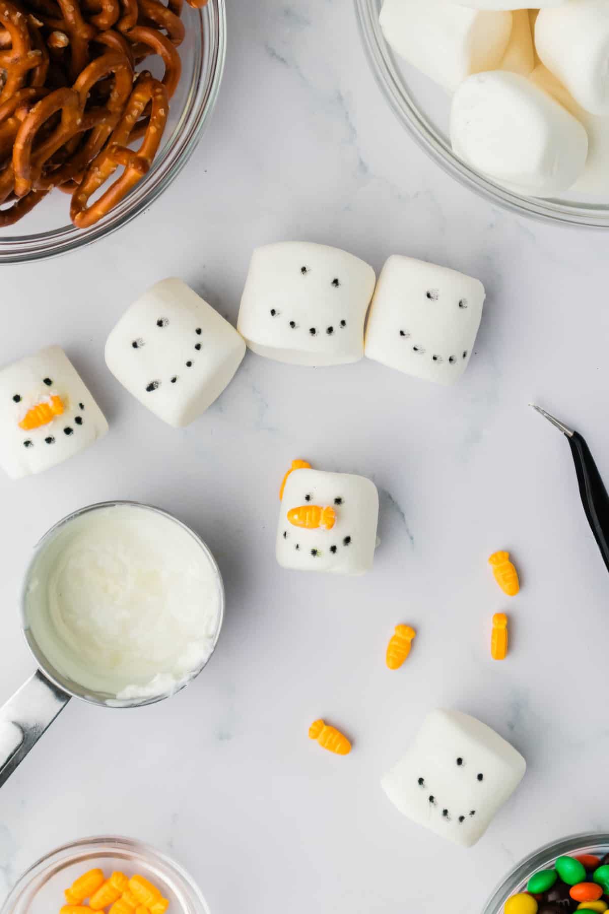 Using leftover Chocolate attach the Carrot Candy to the marshmallow as a nose.