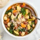 Overhead closeup image of Minestrone Soup in bowl with spoon