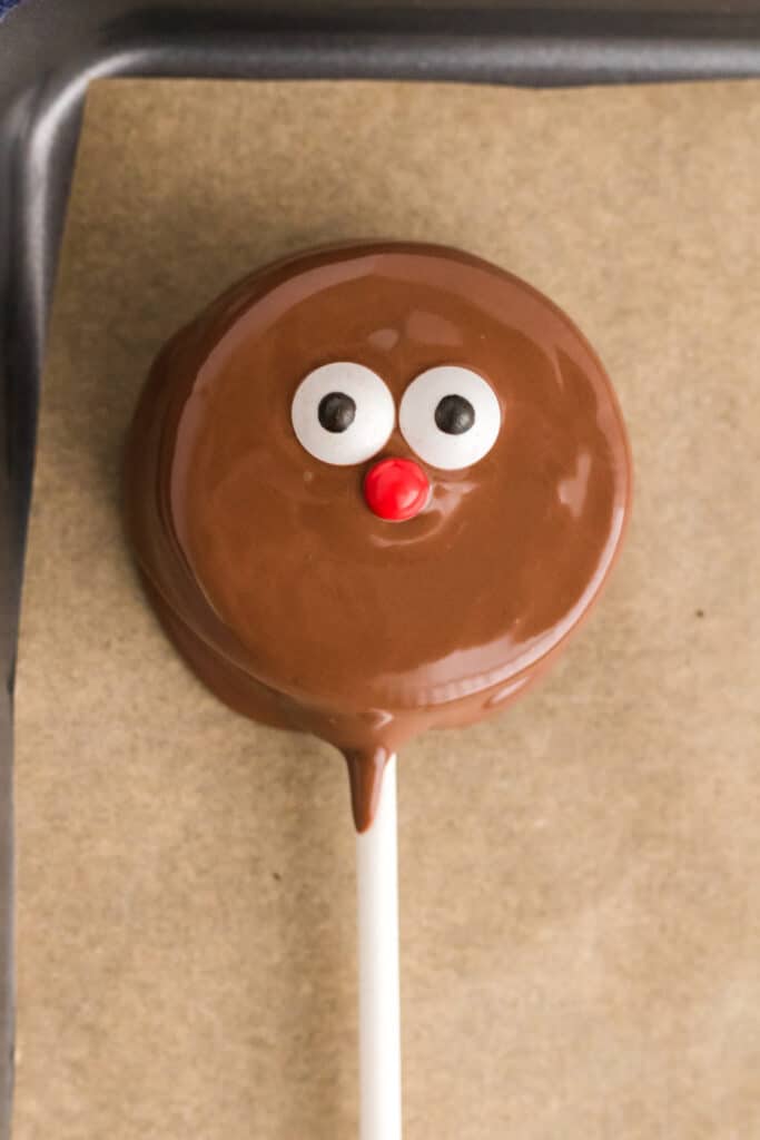 Place onto the Parchment paper and add candy eyes and a red pearl for eyes and nose.