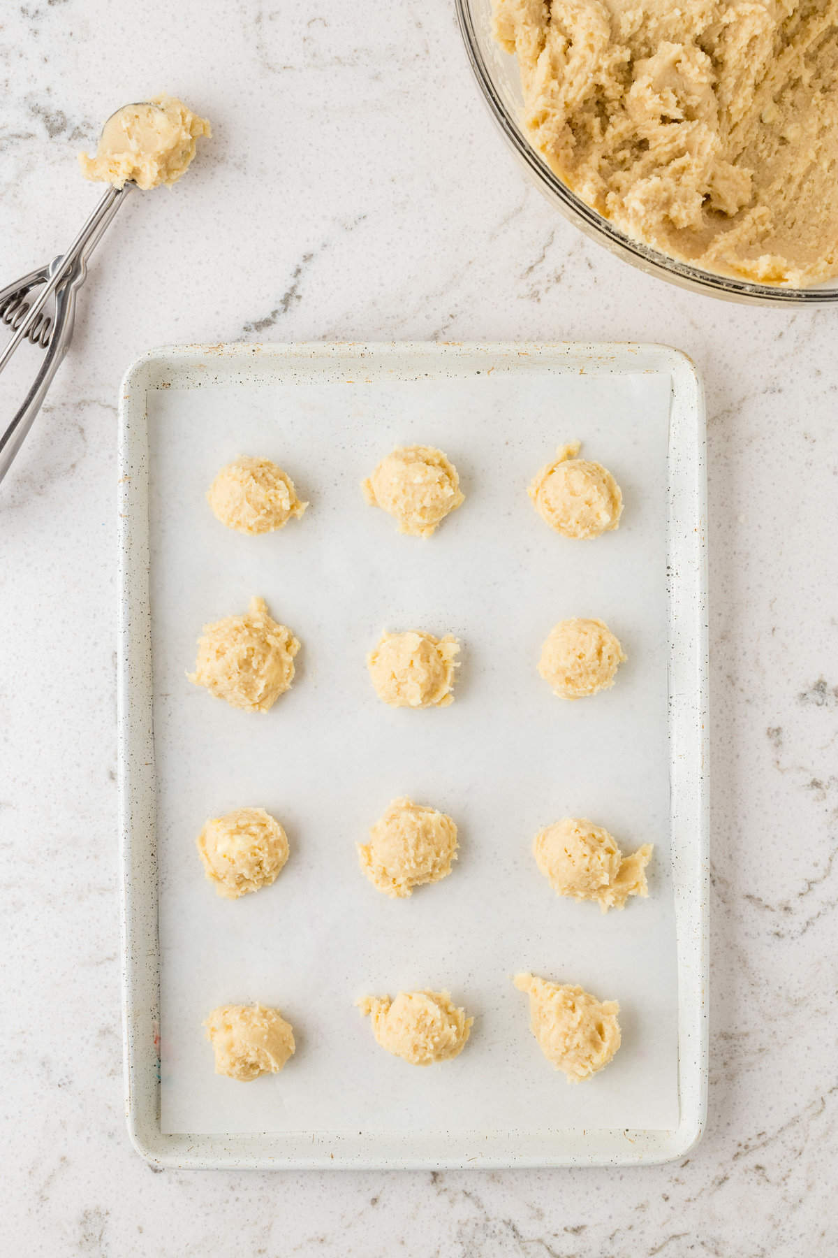 Once chilled use a 1 teaspoon cookie scoop to form small dough balls. Place them 2 inches apart and bake.