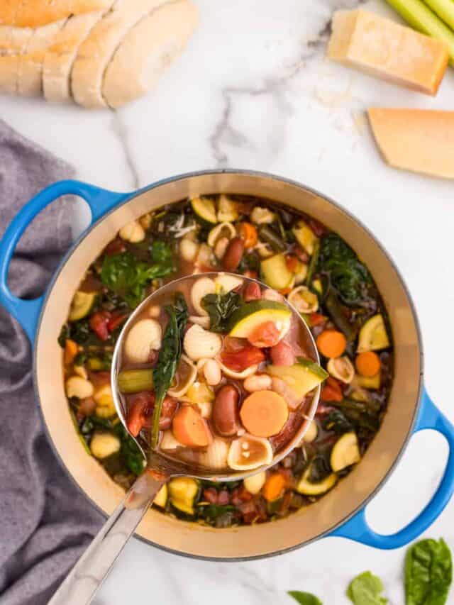 Using large laddle to scoop Minestrone Soup from dutch oven
