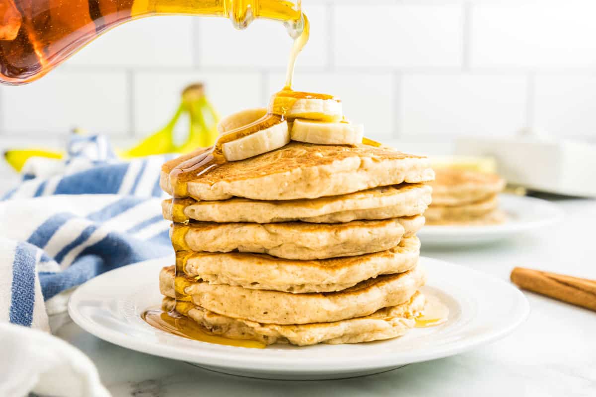 Banana Pancakes Topped with Sliced Bananas and Syrup