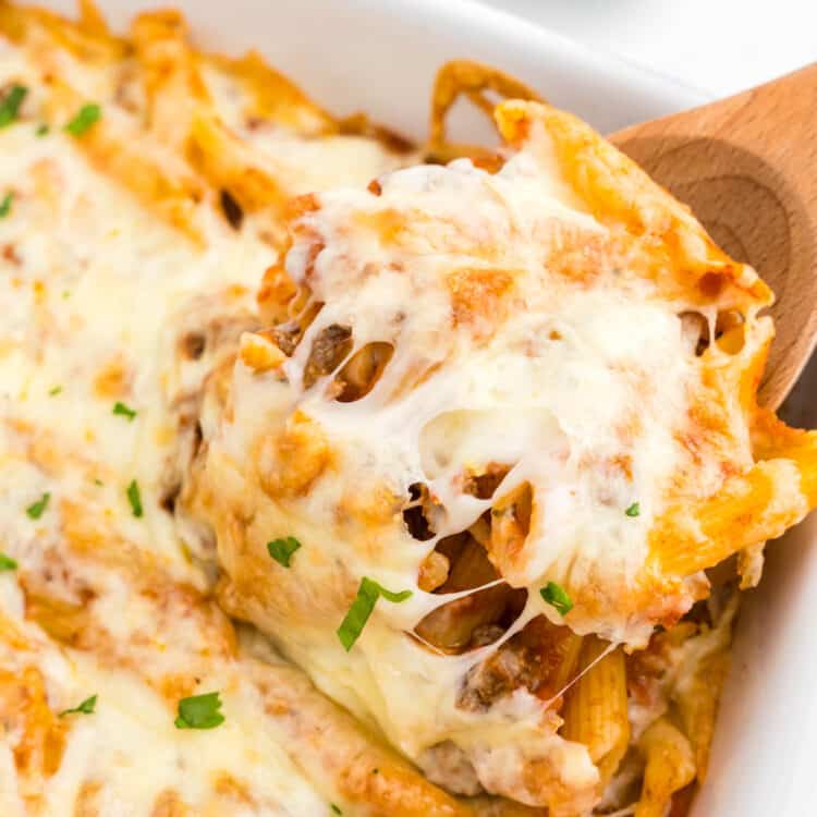 Ground Beef Casserole in baking dish with wooden spoon