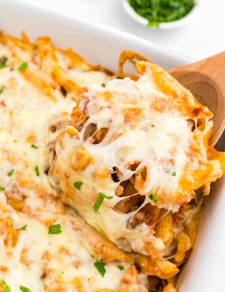 Ground Beef Casserole in baking dish with wooden spoon