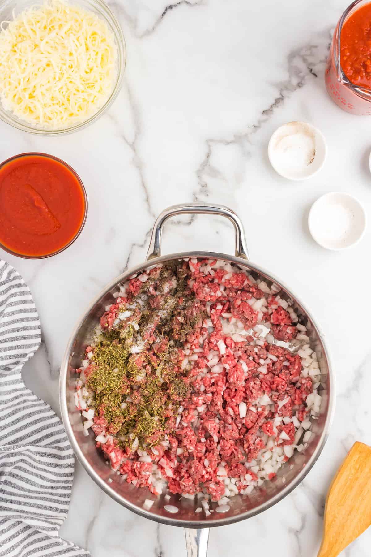 Ground beef and other seasonings in stovetop skillet for Ground Beef Casserole recipe