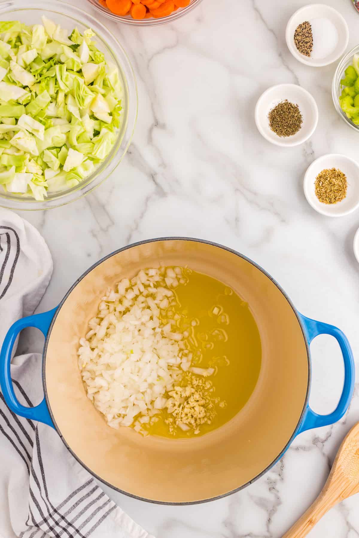 Cooking onion and garlic in olive oil using a Dutch Oven for Cabbage Vegetable Soup