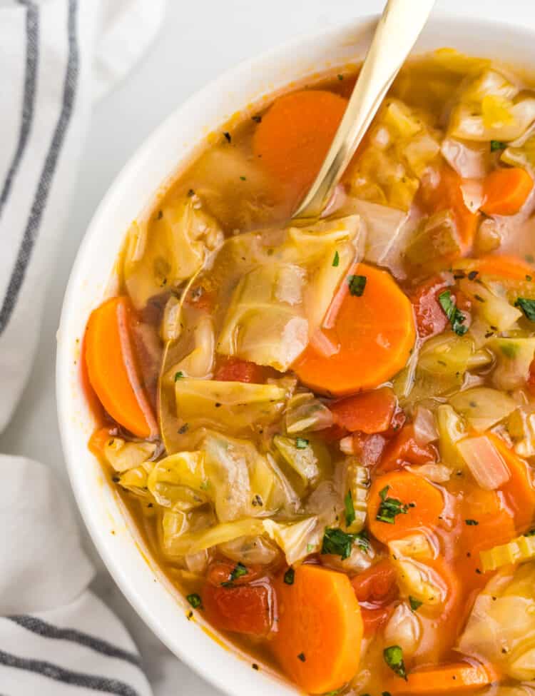 Cabbage Vegetable Soup in bowl with spoon ready to enjoy