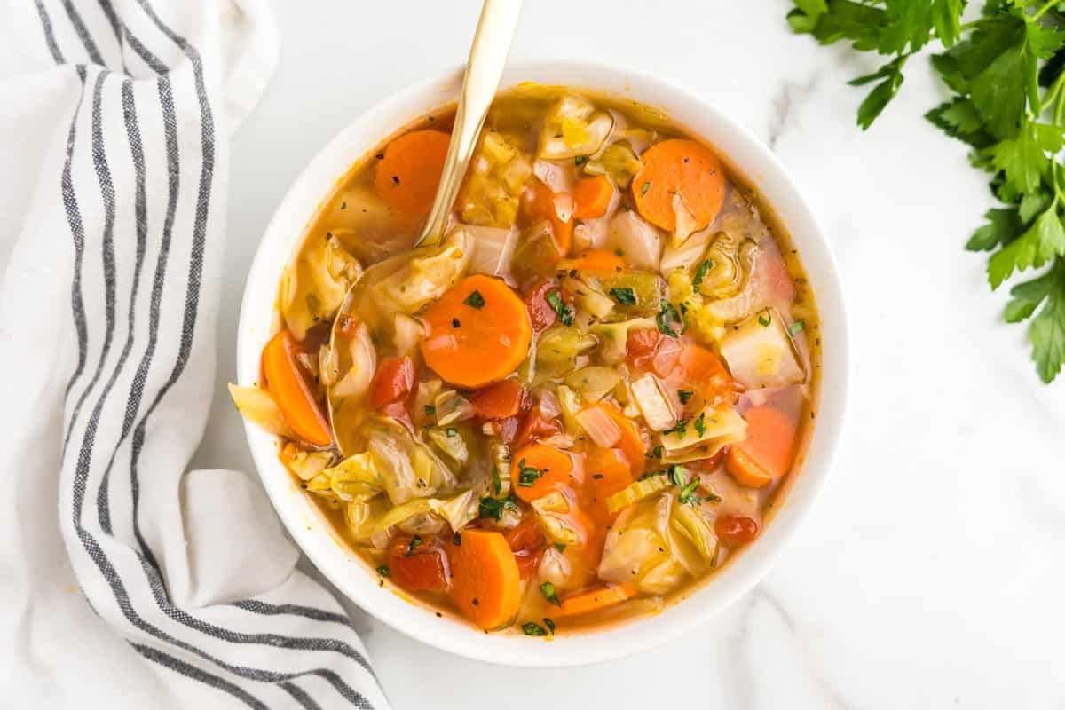 Soup with Cabbage in bowl with spoon