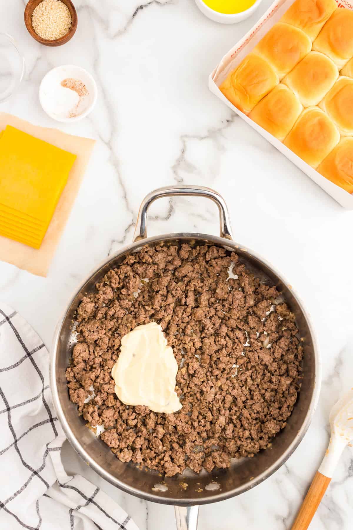 Adding mayo to ground beef skillet for Cheeseburger Sliders recipe