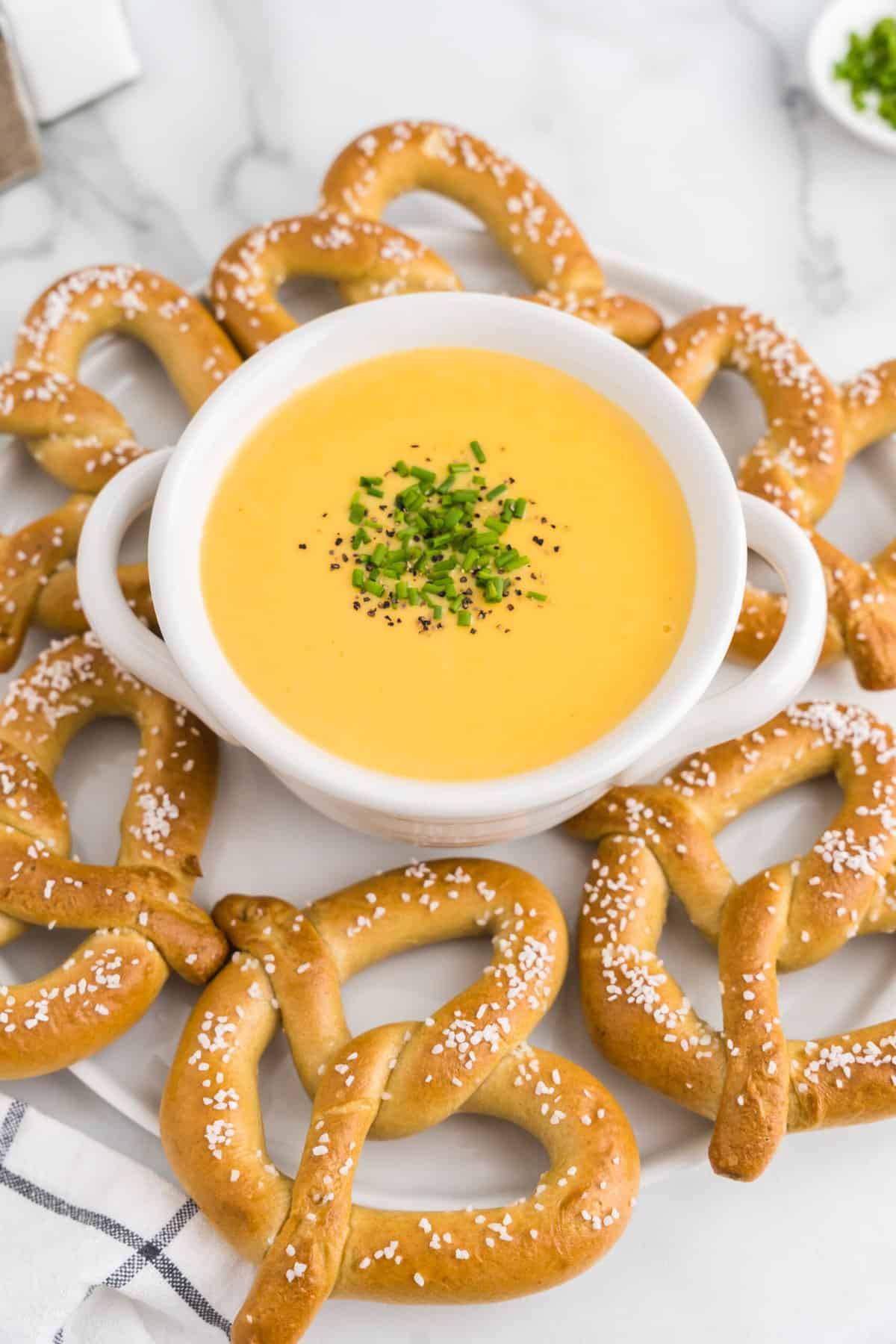 Beer Cheese Pretzel Dip in serving dish with homemade pretzels surrounding bowl