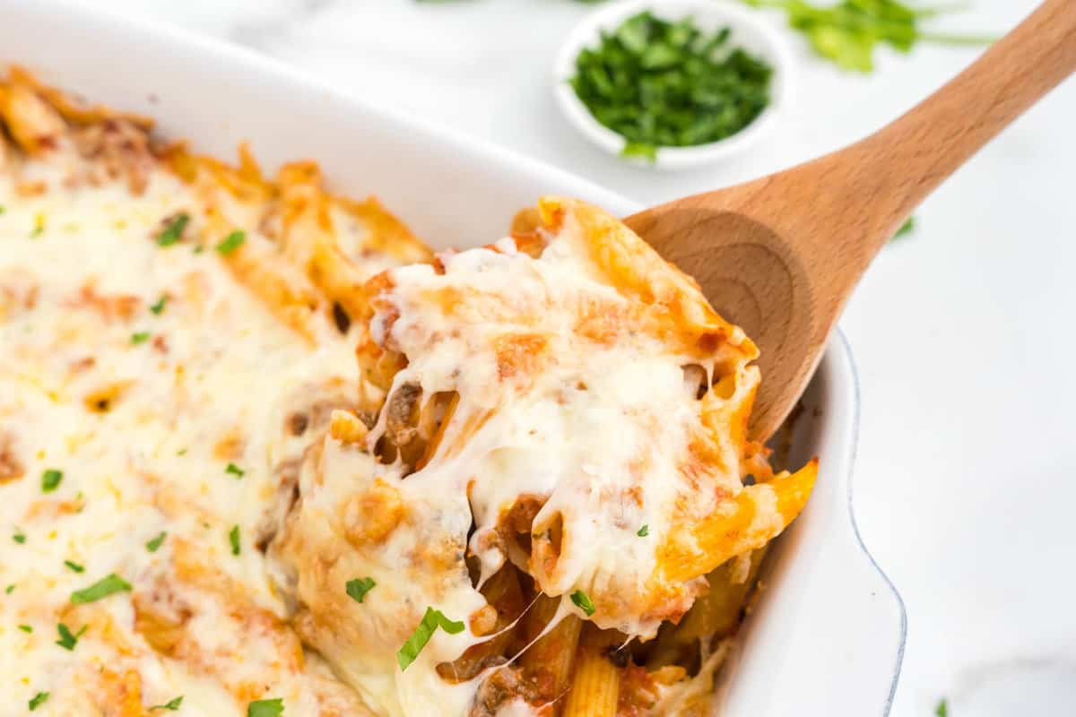 Hamburger Casserole in baking dish with wooden spoon scoop