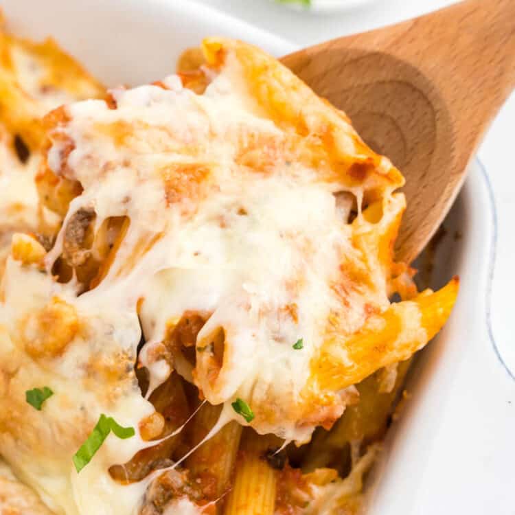 Ground Beef Casserole in baking dish with wooden spoon scoop