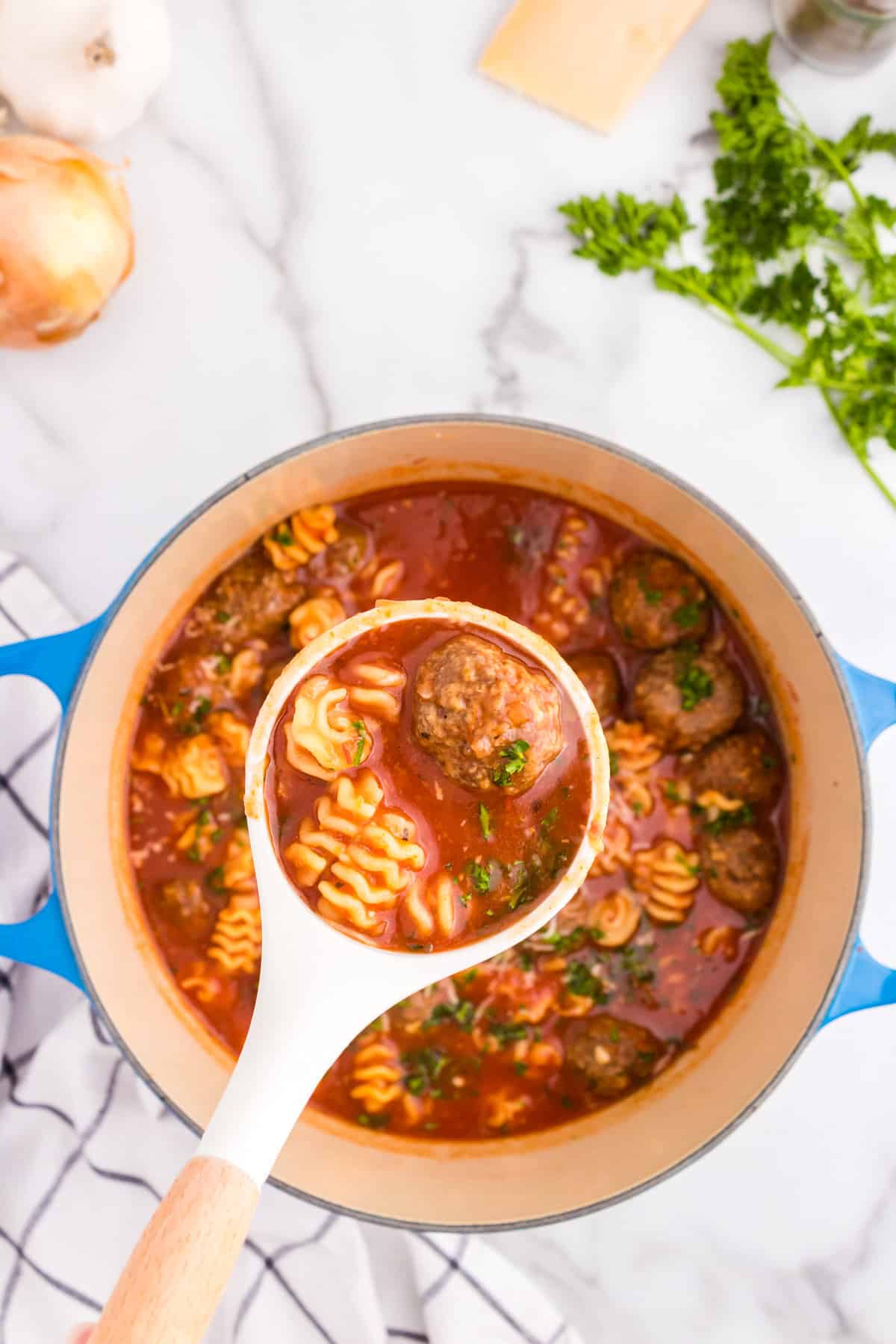 Scooping Meatball Soup from stock pot 