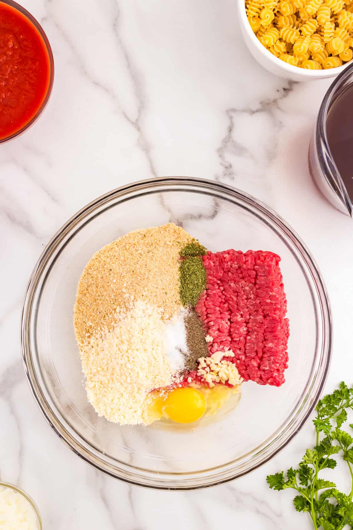 Ground beef and seasonings in mixing bowl for meatballs for  Italian Meatball Soup recipe