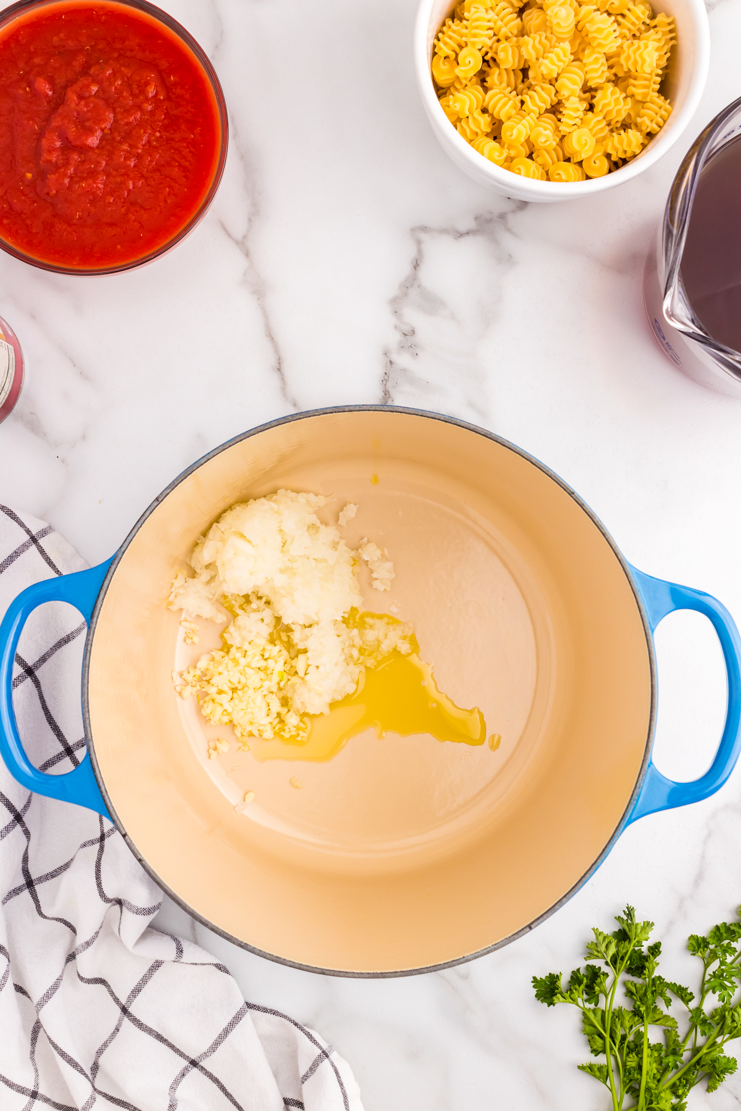 Olive oil and garlic in stock pot for Meatball Soup