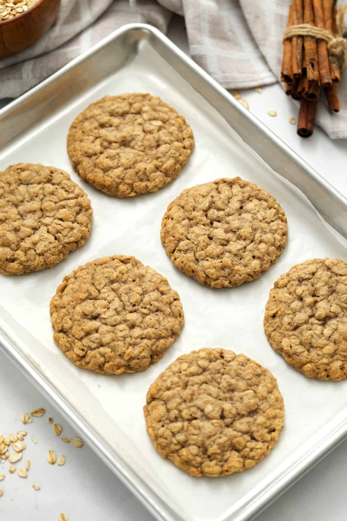 Sheet pan with baked oatmeal cookies on it