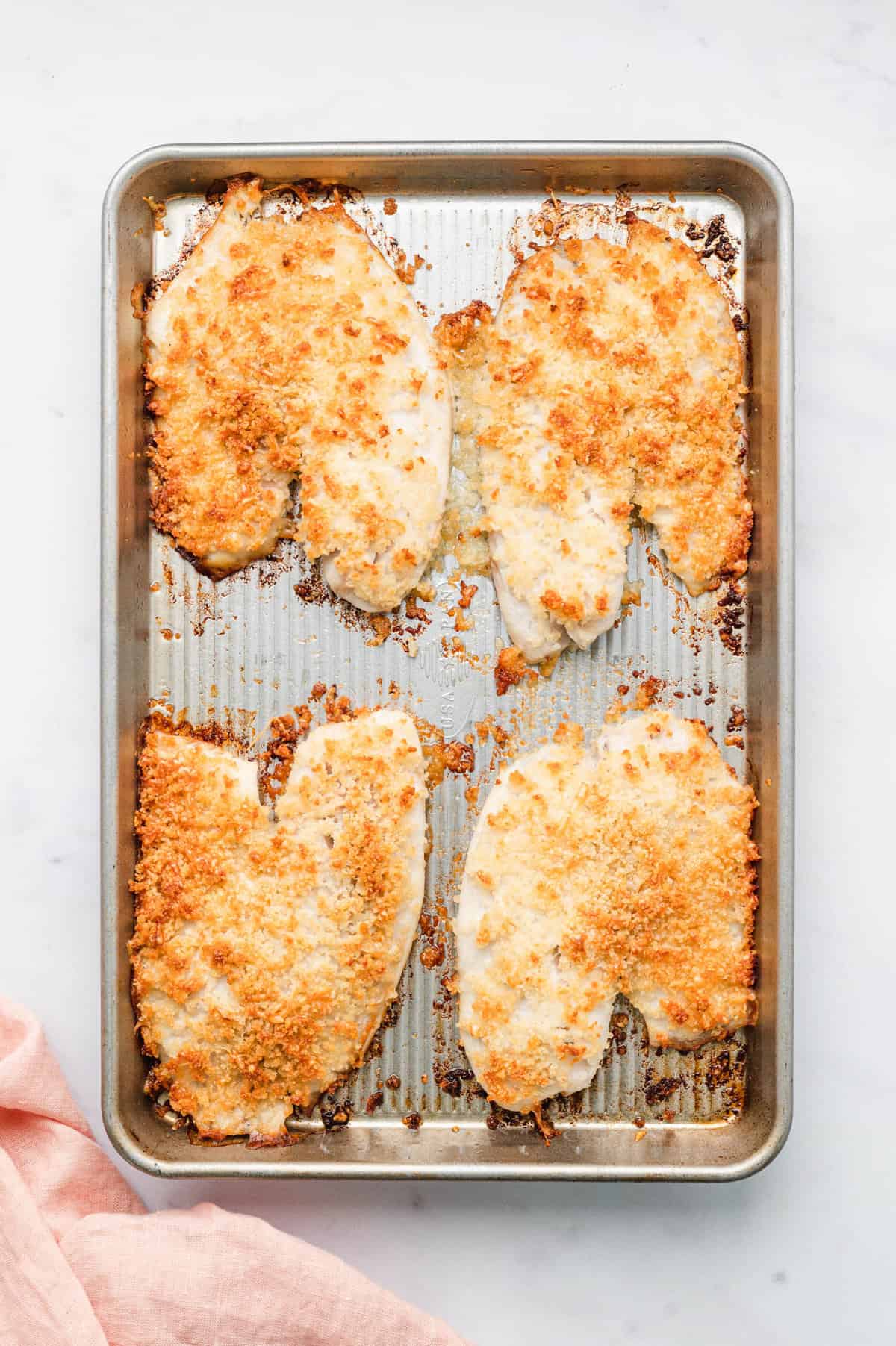 Parmesan Crusted Tilapia on baking sheet just out of oven