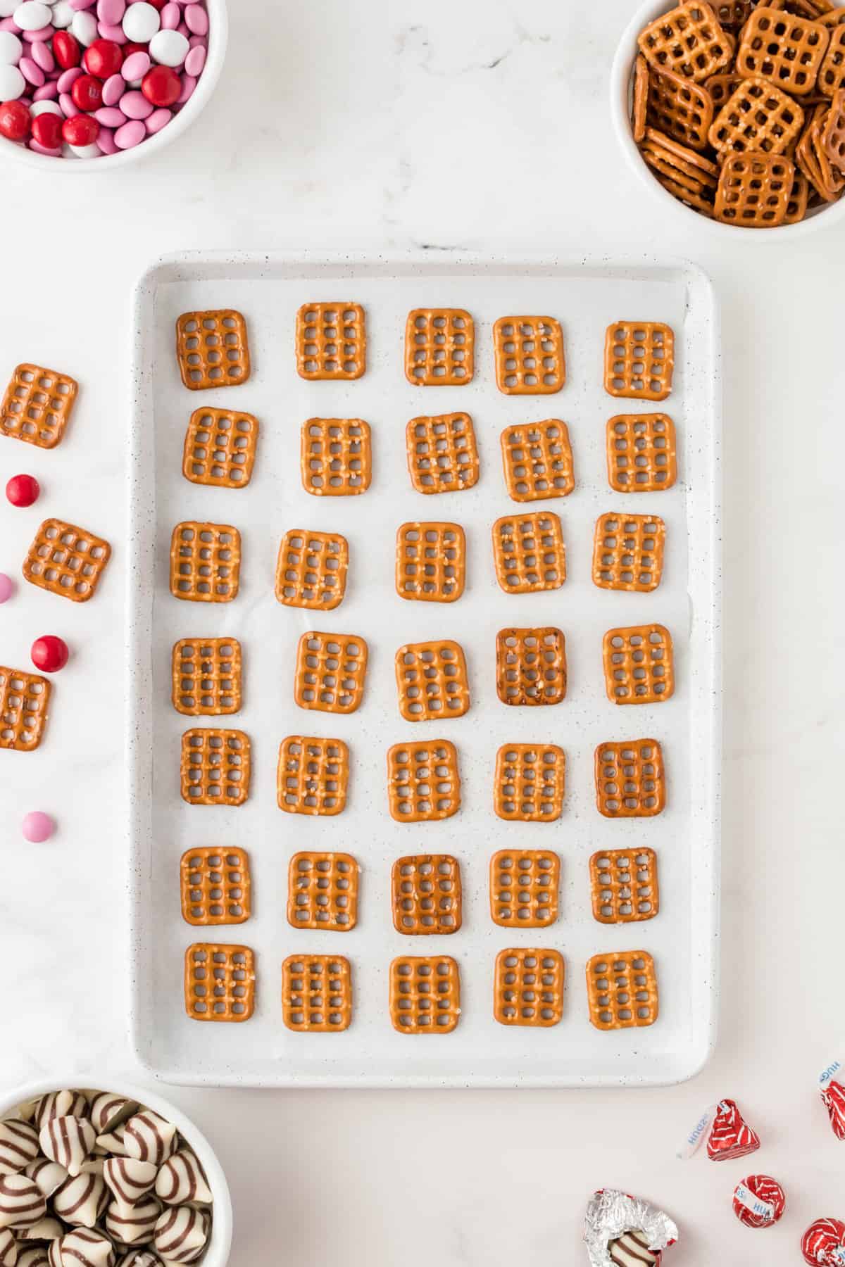 On a Baking sheet lined with Parchment Paper place as many square pretzels as you'd like.