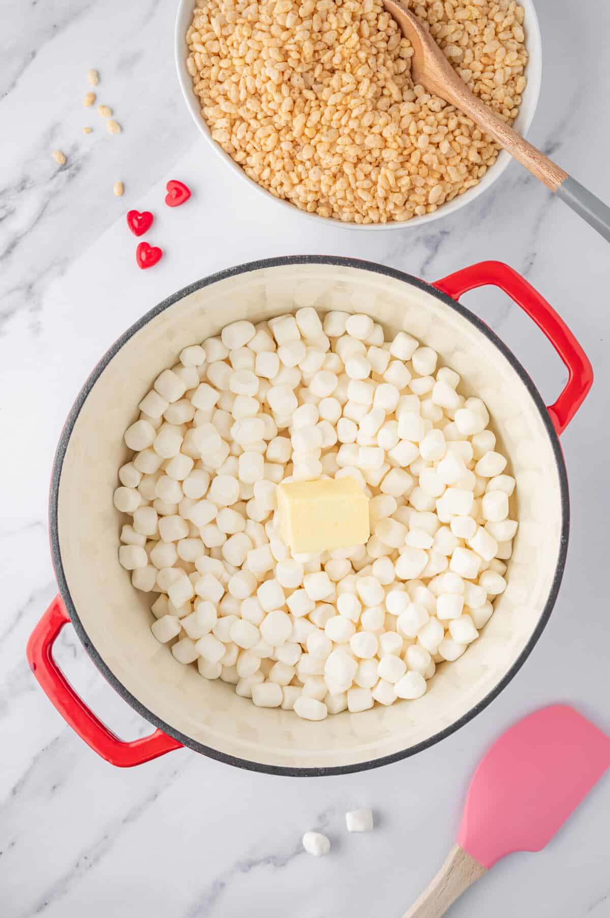 In a 5qt dutch oven, melt marshmallows and butter on low . Stir it often so it doesn't burn.