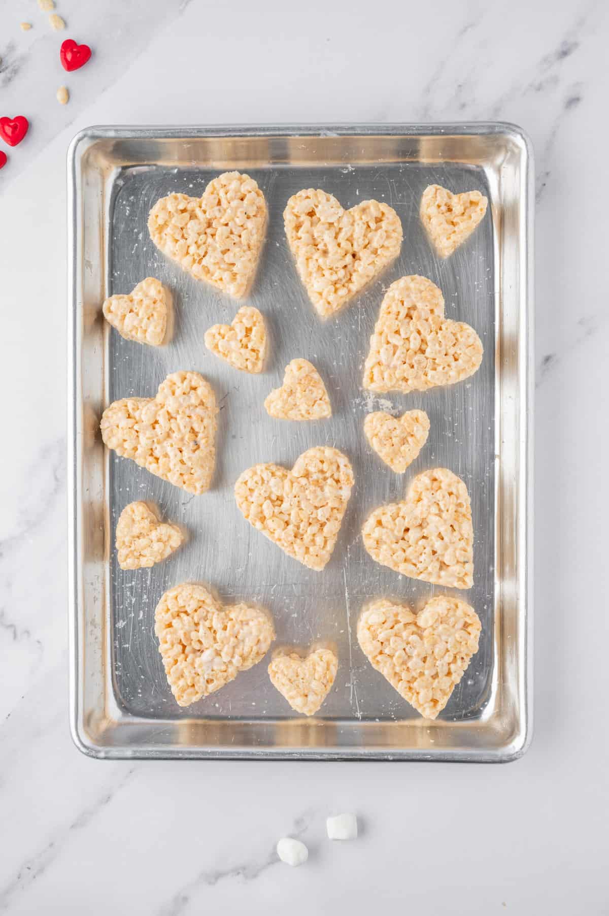 Put all of the Cut out hearts onto a baking sheet.