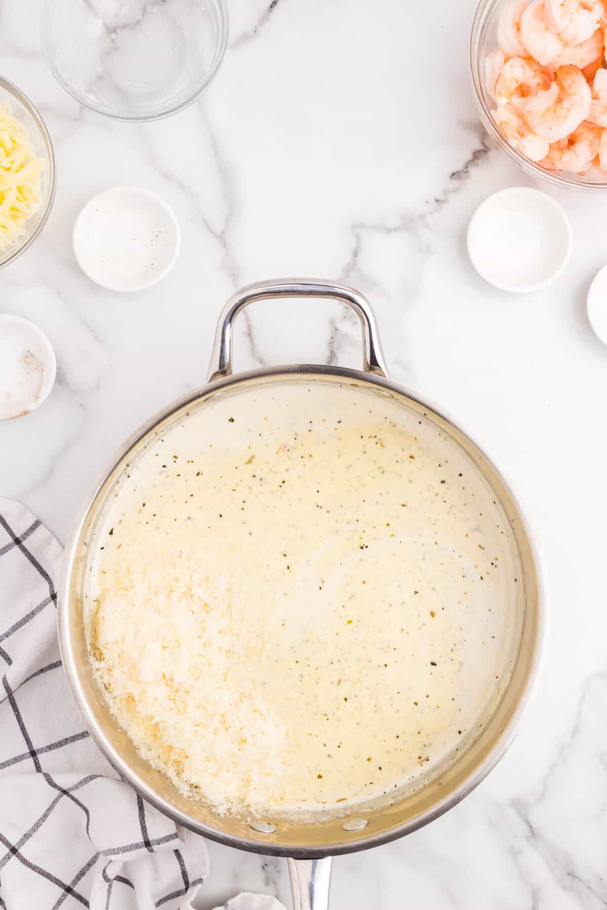 Alfredo ingredients in stovepot saucepan for Shrimp Alfredo Bake recipe