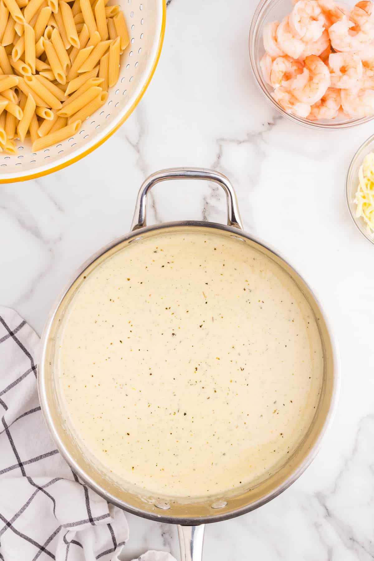 Combined alfredo ingredients in stovepot saucepan for Shrimp Alfredo Bake recipe