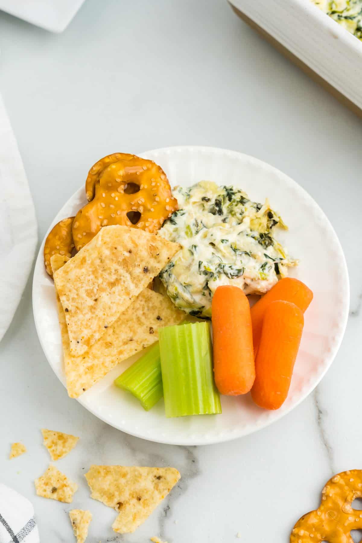 Spinach Artichoke Dip on plate with dipper options