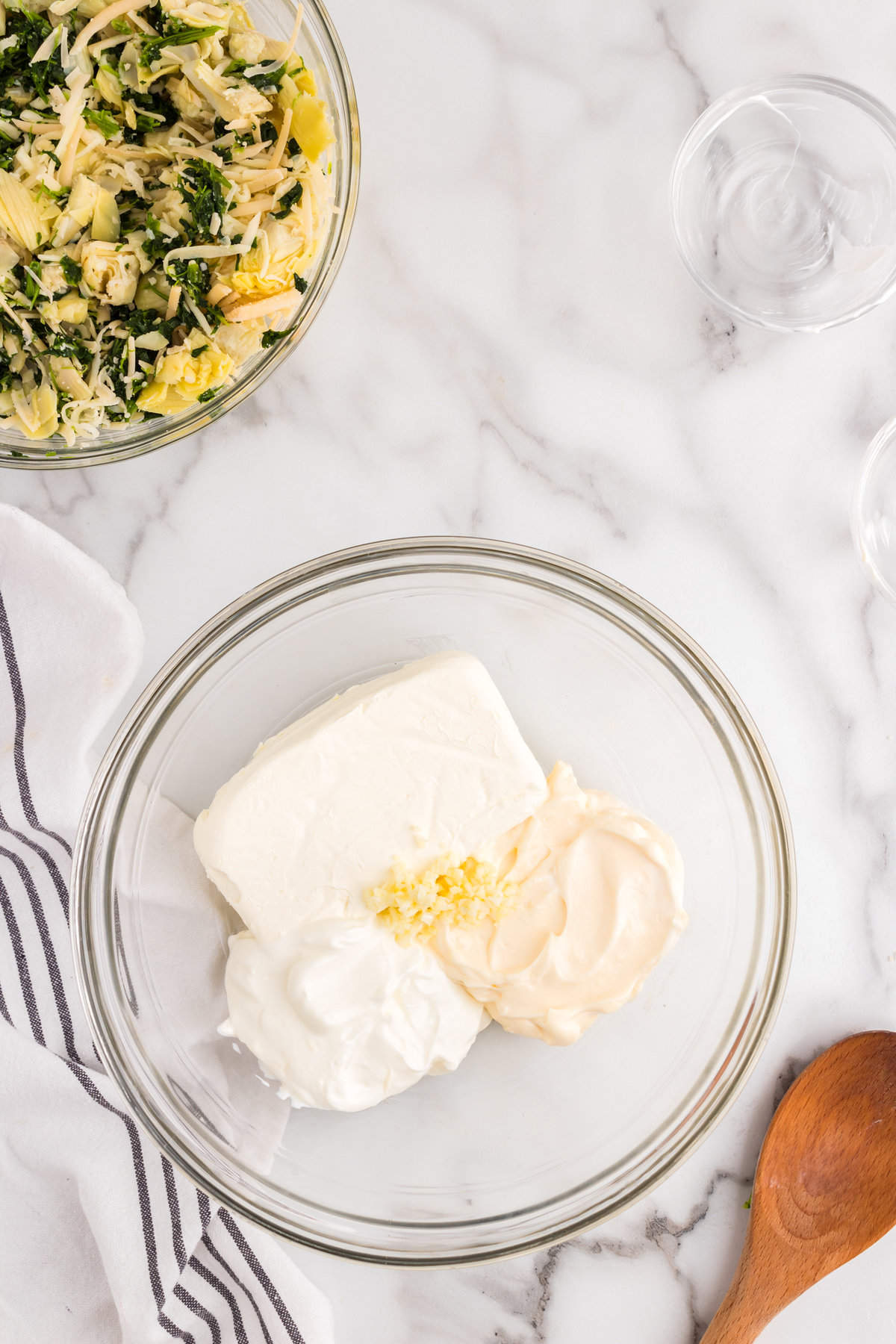 Using a seperate mixing bowl to cream together dairy products for Spinach Artichoke Dip