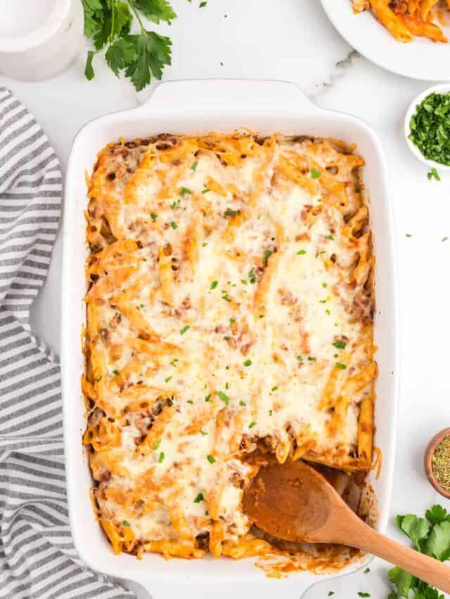 Using wooden spoon to scoop the first bite out of Ground Beef Casserole in baking dish