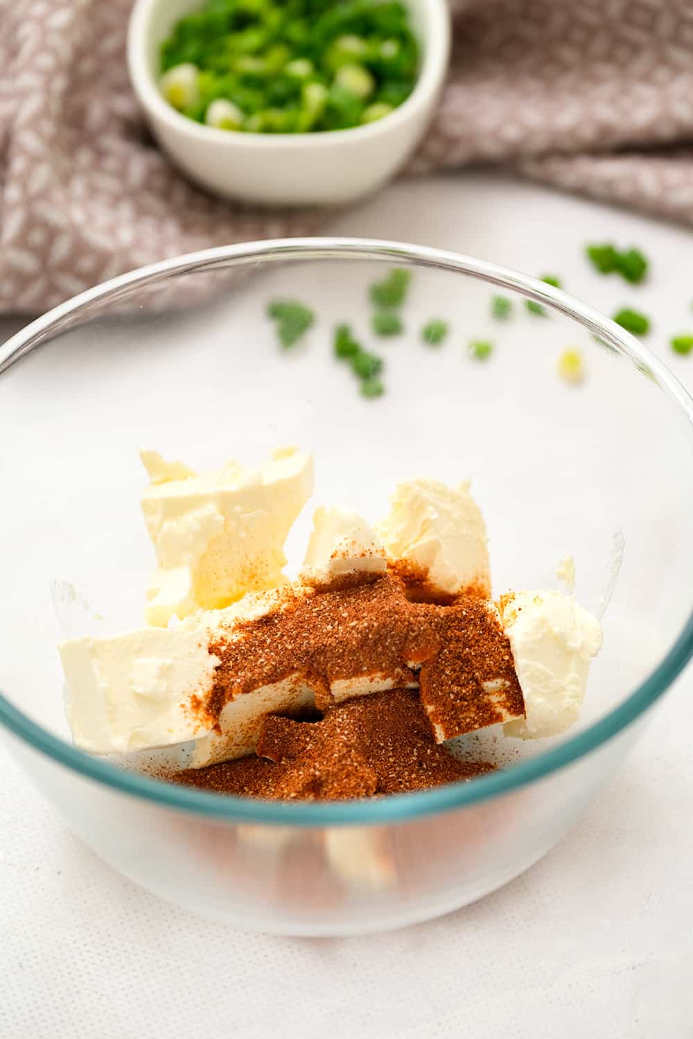 Glass bowl with cream cheese and taco seasoning