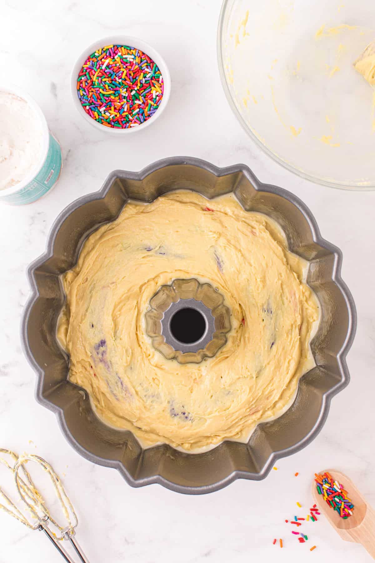 Add a layer of non-colored cake mix to the top of all of the colored cake mix and bake.