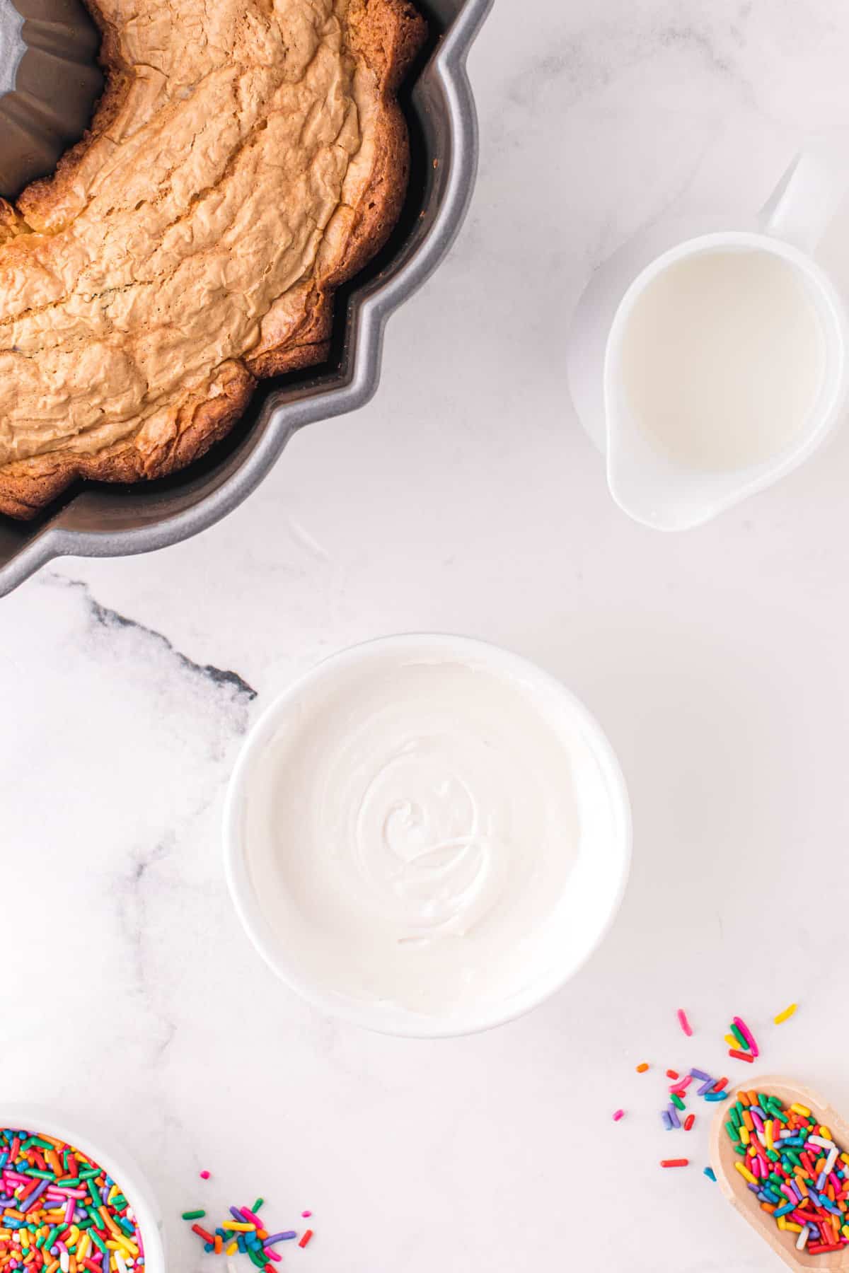 Mix together frosting and half and half until it is a thick glaze to pour ontop of the bundt cake