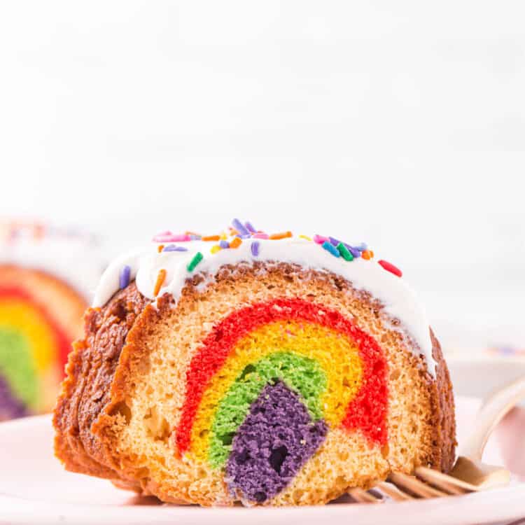 Chunk of bundt cake on a plate showing the inside of the cake with all the different colors.