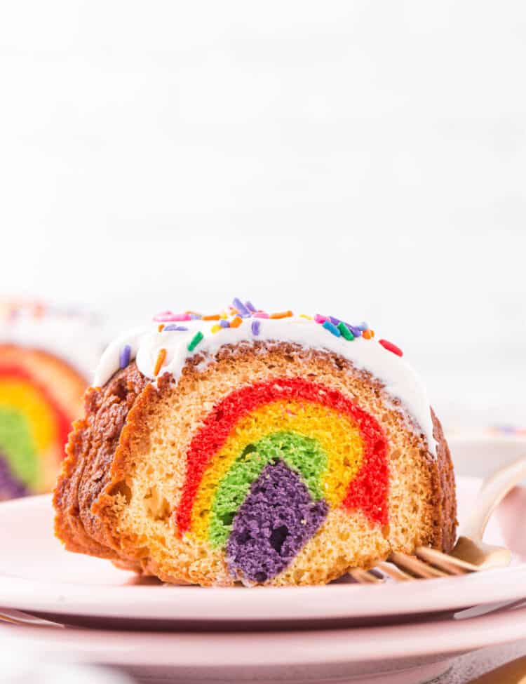 Chunk of bundt cake on a plate showing the inside of the cake with all the different colors.