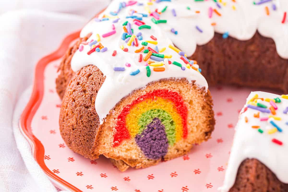 Overhead image of a piece cut out of the bundt cake so you can see the colors inside.