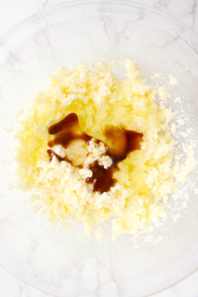 Add Vanilla and Egg whites to the butter and sugar and beat together until smooth.