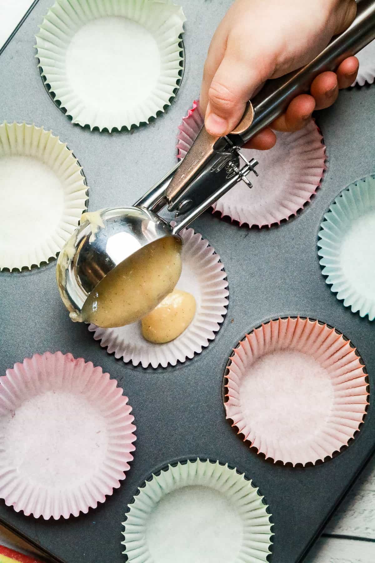 Using a large ice cream scoop filled ¾ of the way full, pour into the cupcake liner.