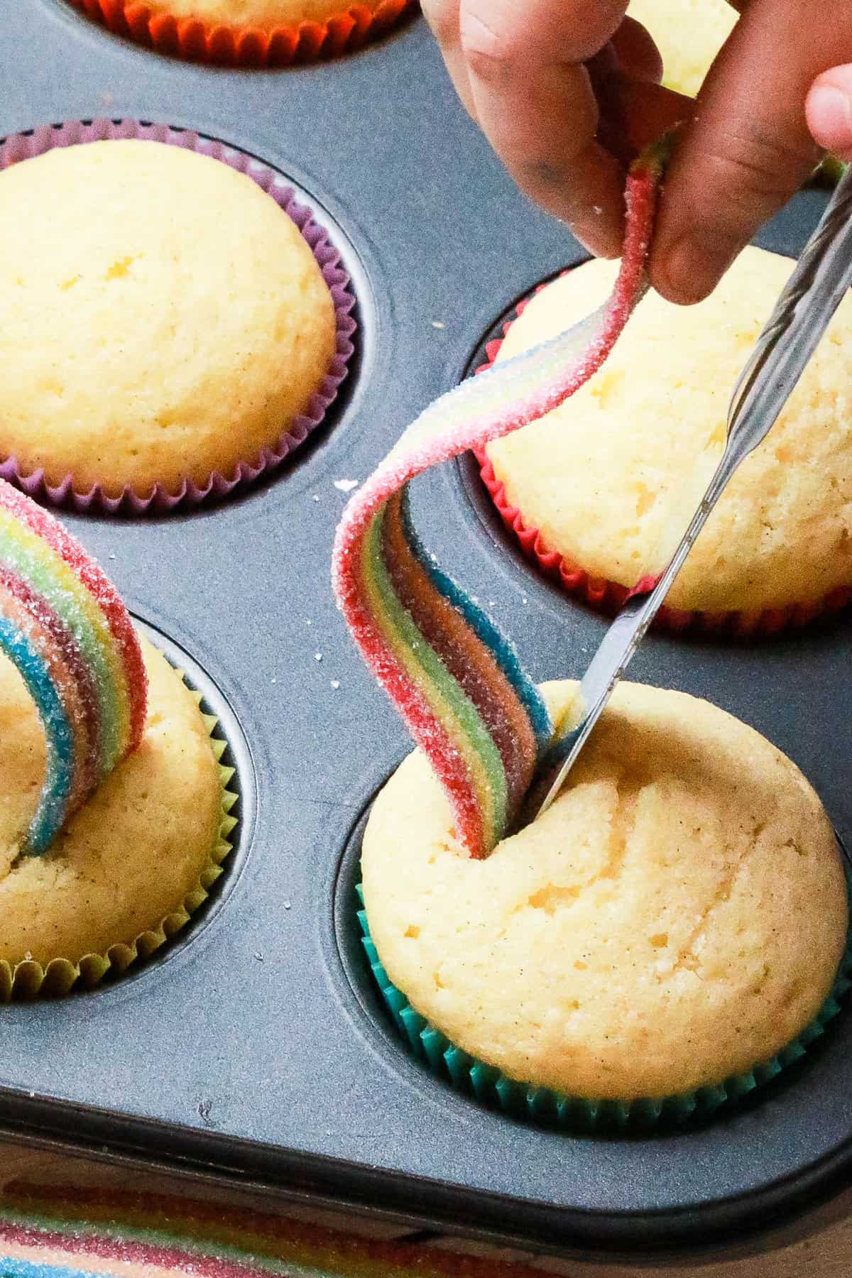 Once the Cupcakes are baked, cut two slits in the top of the cupcake for the Airhead Extreme Candy.