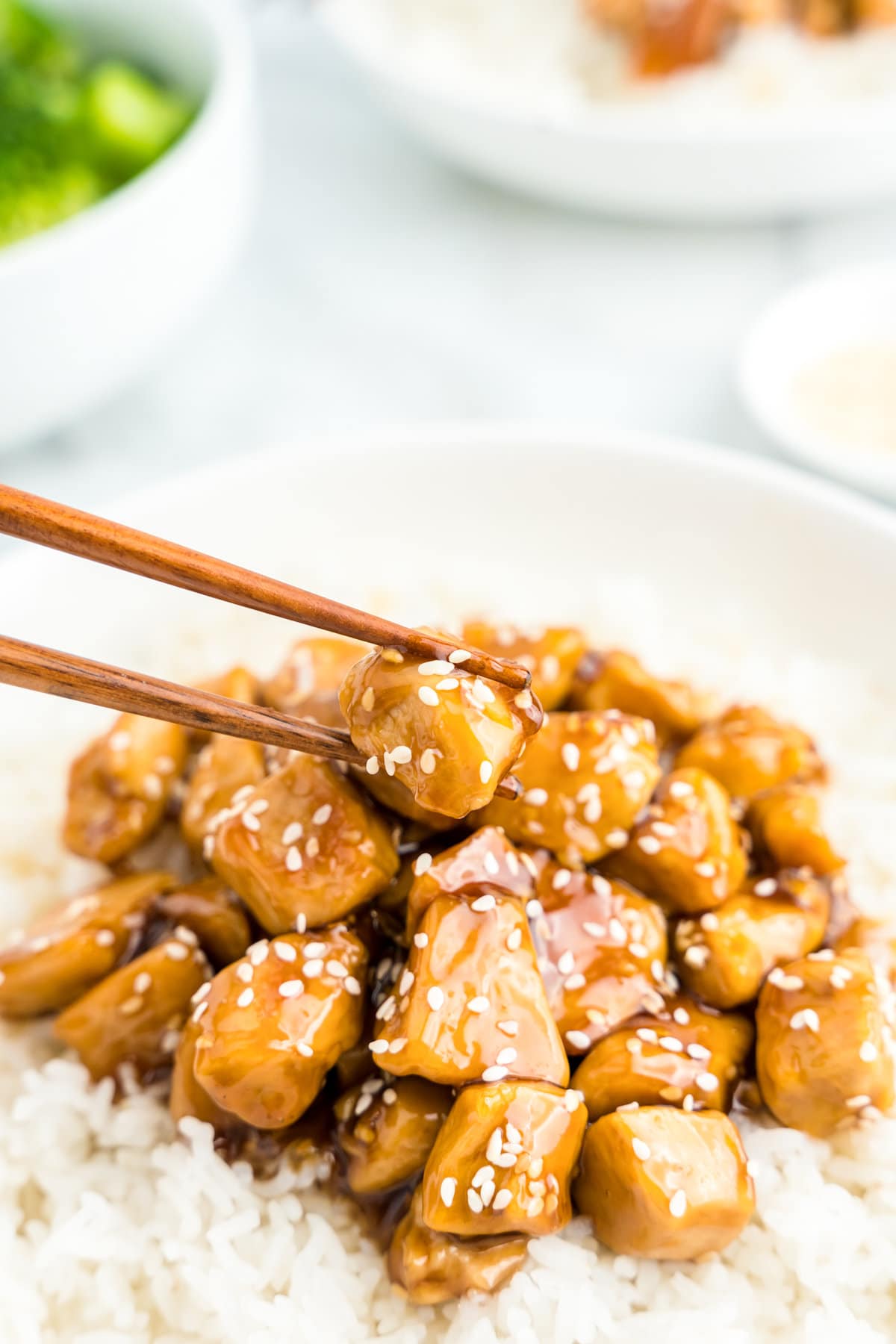 Teriyaki Chicken over bed of rice in bowl with chopsticks