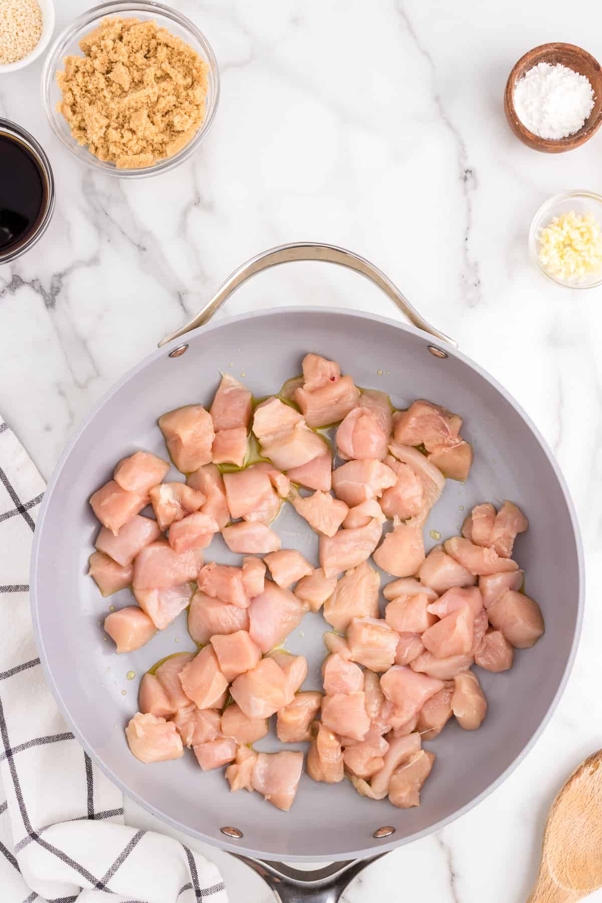 Chuncked chicken in stovetop skillet with olive oil for Teriyaki Chicken recipe