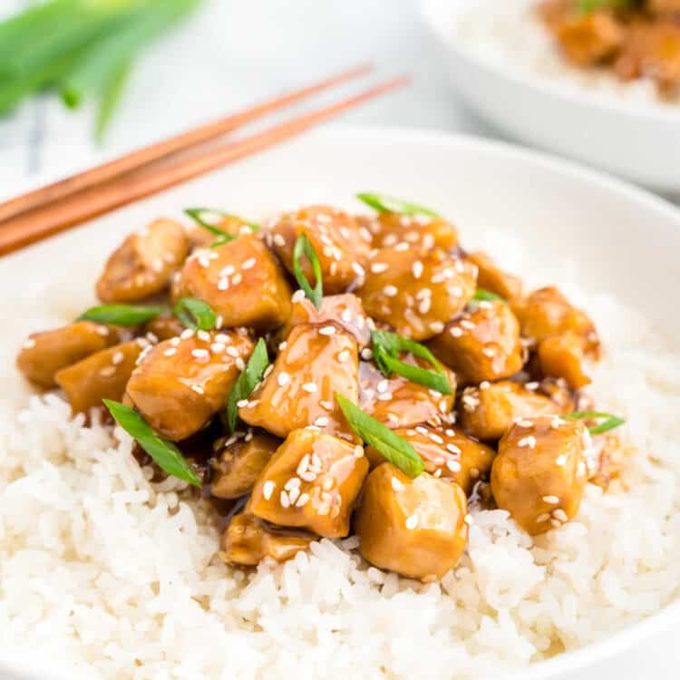 Teriyaki Chicken on a bed of white rice in bowl with chopsticks