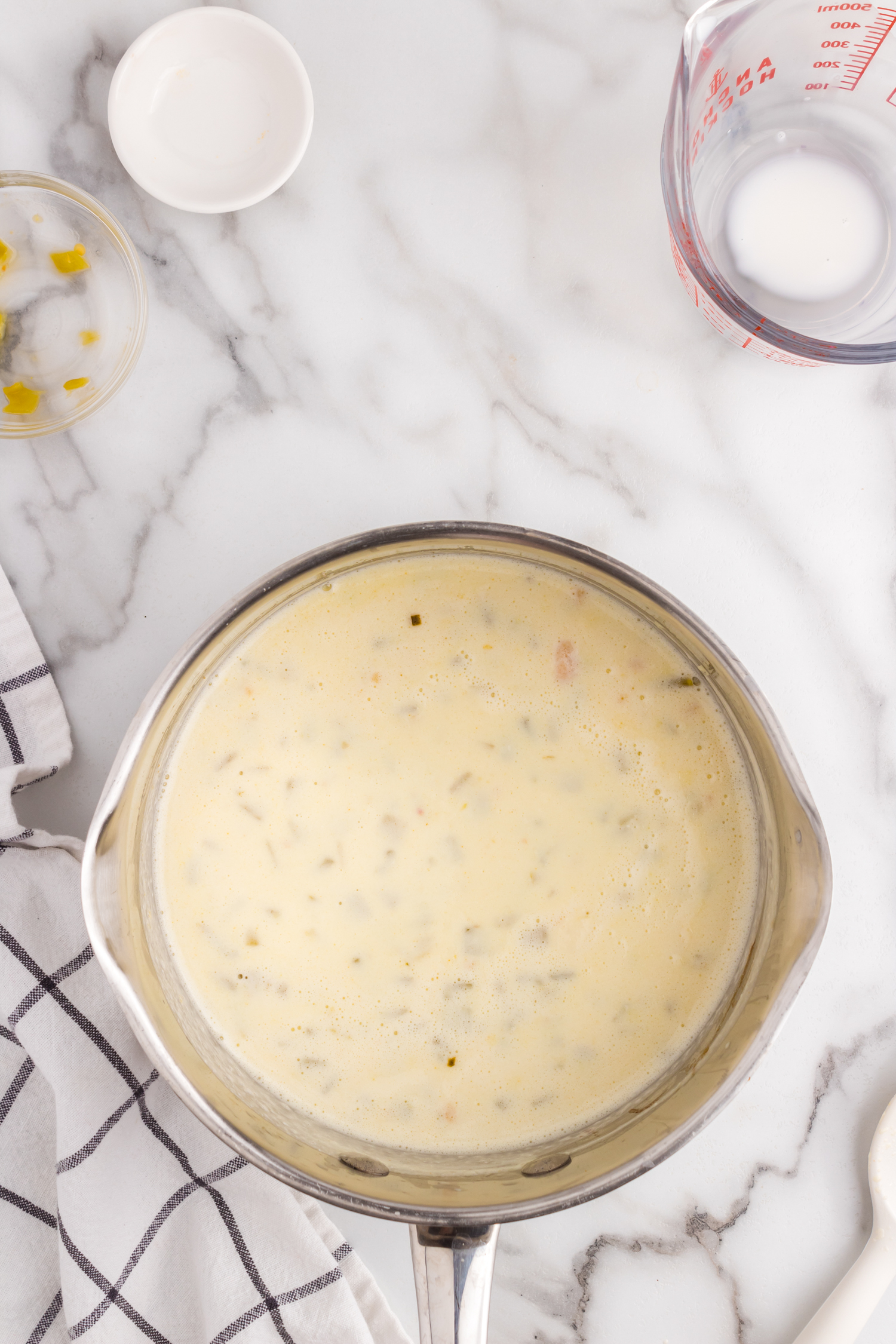 Perfectly blended cheeses and seasonings in saucepan for Queso Dip recipe