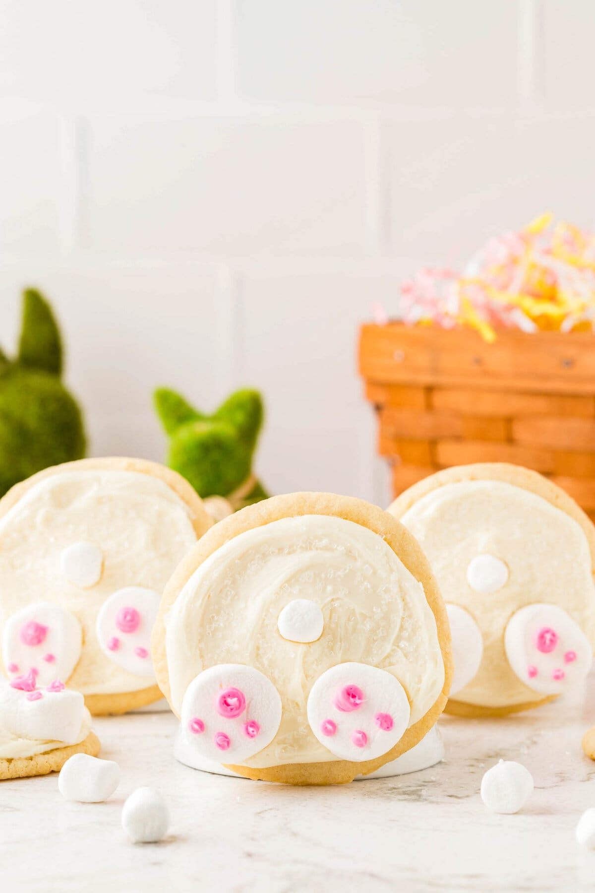 Three bunny butt cookies completed and standing on their side to show they look like bunny butts.