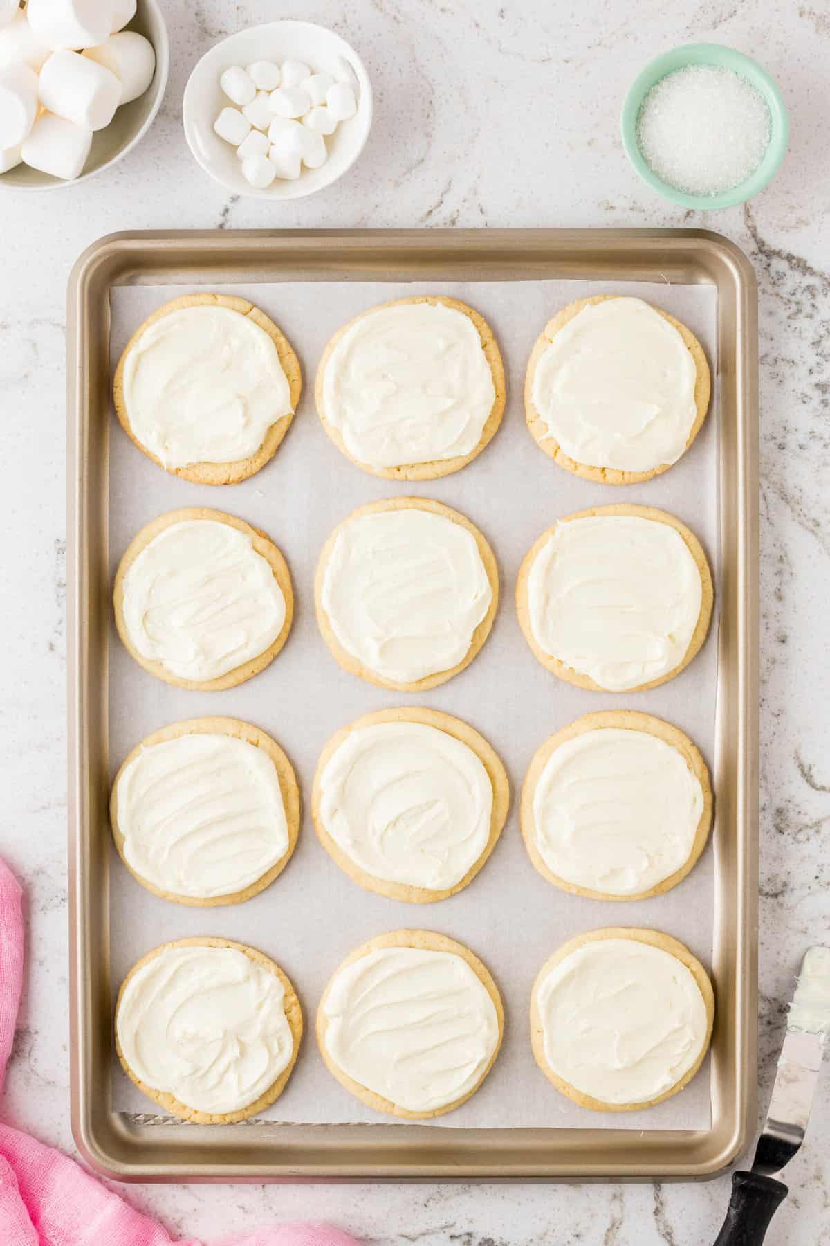 Once cookies are cooled, spread white frosting on top.
