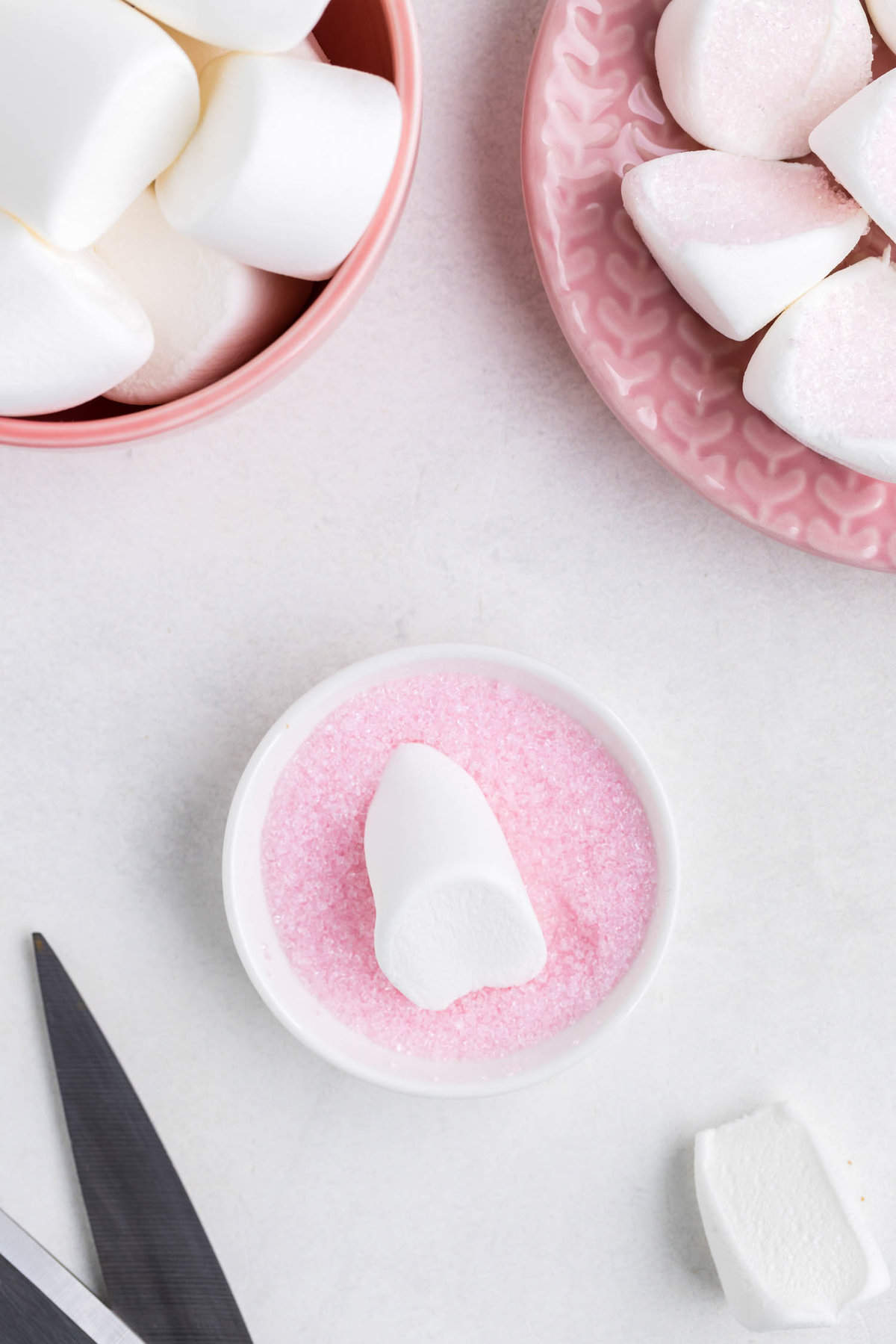 Cut the large marshmallows in half diagonally and dip into pink sugar.