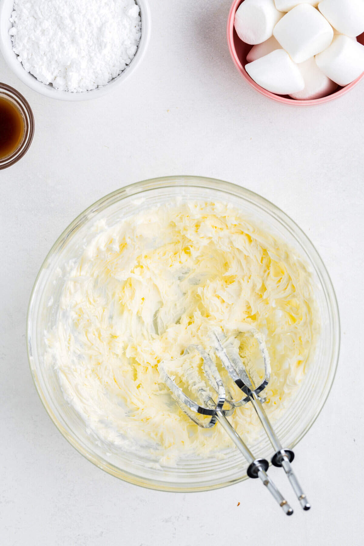 Add butter to a medium bowl and beat with hand mixer.