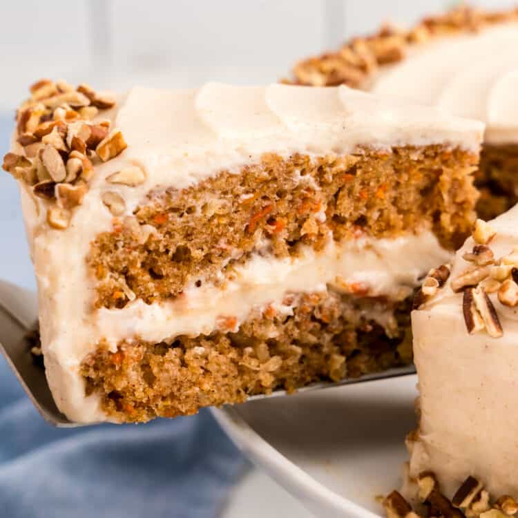 Slice of Carrot Cake being removed from cake using a spatula