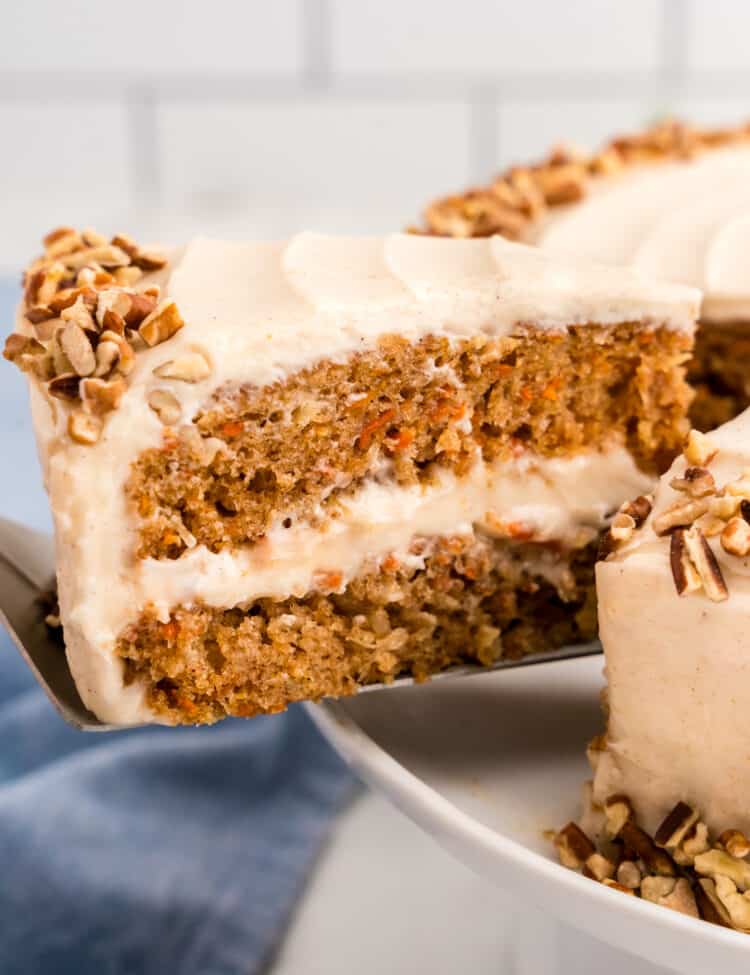 Slice of Carrot Cake being removed from cake using a spatula