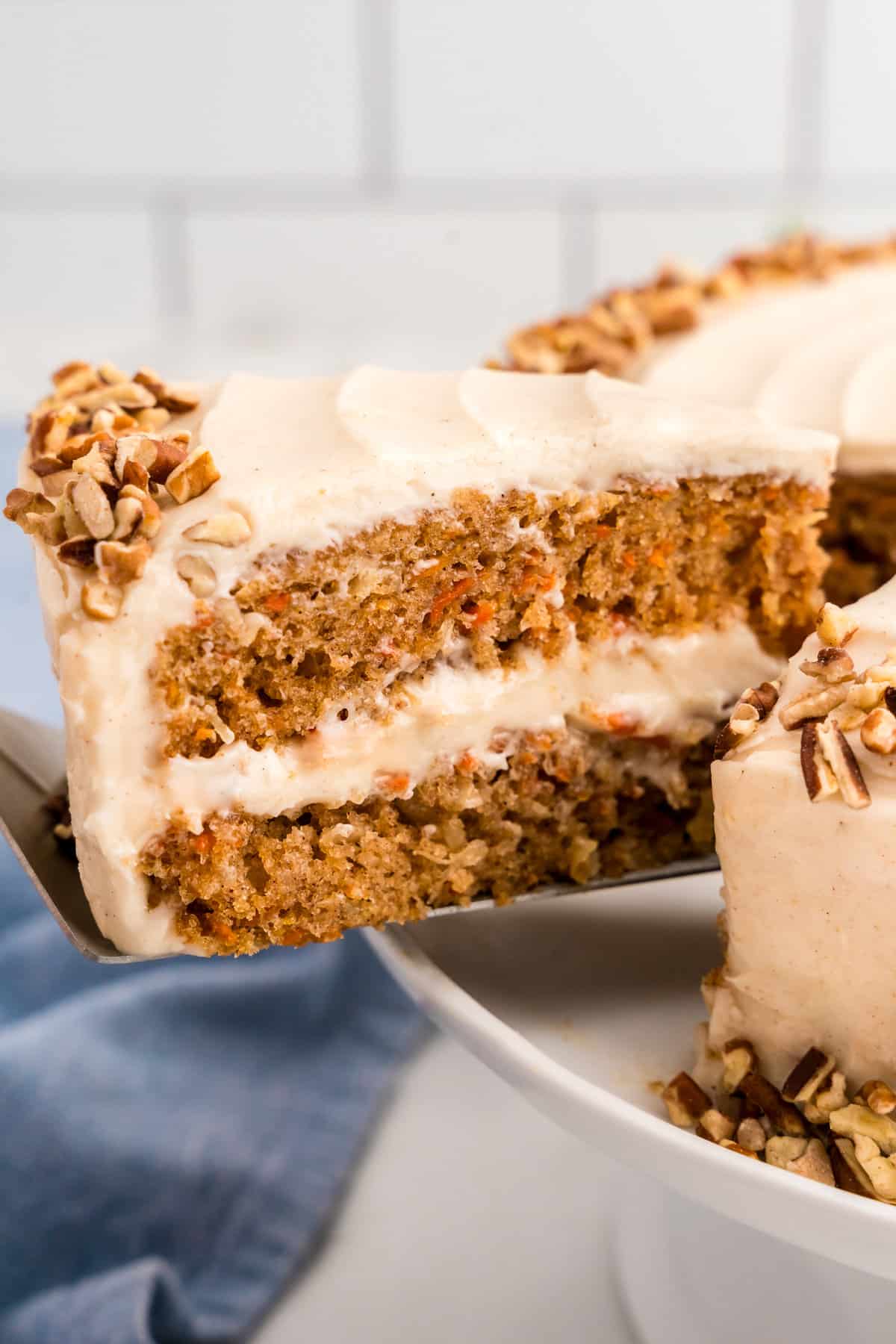 Slice of Carrot Cake being removed from cake using a spatula